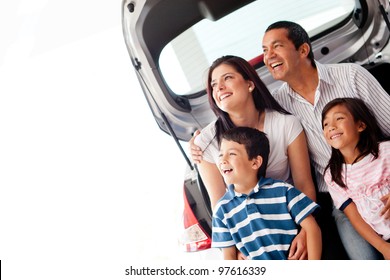 Happy Family With Their New Car Smiling