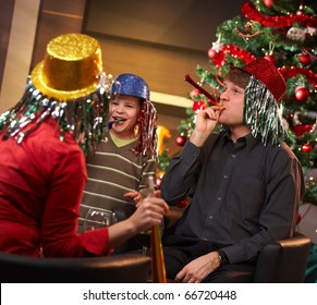 Happy Family Of Three Celebrating In New Year Eve Hat At Home.?