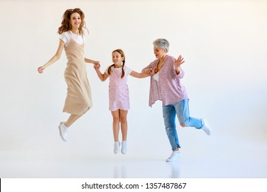  Happy Family Three Generations   Grandmother, Mother And Child Dancing, Jumping On White Background 
