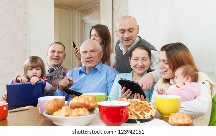 Happy Family Of Three Generations Or Group Of Friends With Electronic Devices