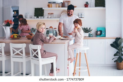 Happy Family With Three Kids Having Breakfast At Home In The Morning, Cute Kitchen Interior