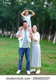 Happy family of three playing in the park high quality photo - Shutterstock ID 2006002037
