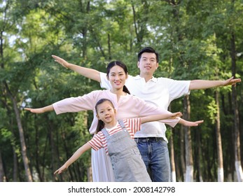 Happy family of three playing in the park high quality photo - Shutterstock ID 2008142798