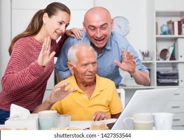 Happy Family Of Three Set Up A Web Camera For Video Calls At Home 