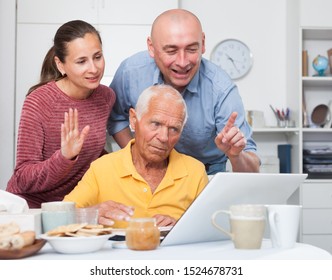 Happy Family Of Three Set Up A Web Camera For Video Calls At Home 