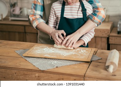 Happy Family Time Parent Kid Diy Baking Cake In Kitchen On Mothers Day. Unrecognized Asian Woman Mom Teaching Child Daughter Kneading Dough For Bread On Easter. Close Up Female And Little Girl Hands