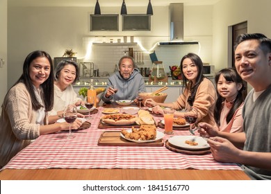 Happy family time and relationship, Asian big family having small Christmas party eating food together at home. Kid is happy to see parent, cousin preparing food and bring it to dining table at home. - Powered by Shutterstock