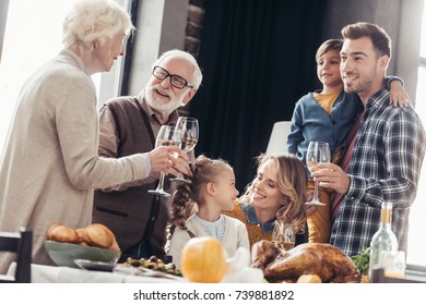 happy family toasting with wine glasses on holiday dinner