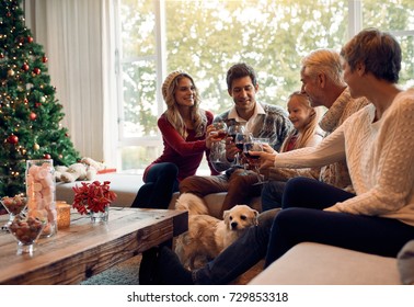 Happy Family Toasting With Wine On Christmas Eve. Family Gathering At Home For Christmas Festival, Celebrating With Wine.