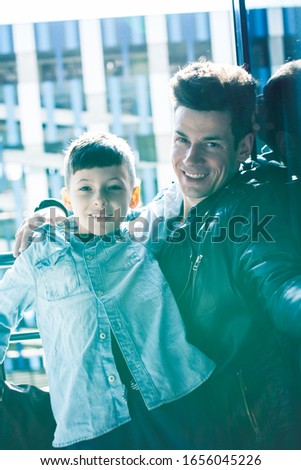 happy family together concept, father and son at window huggings, enjoying sunlight, lifestyle people at summer