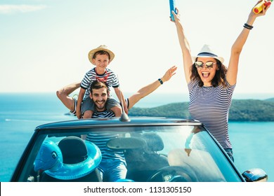 Happy Family Travel By Car To The Sea. People Having Fun In Cabriolet. Summer Vacation Concept