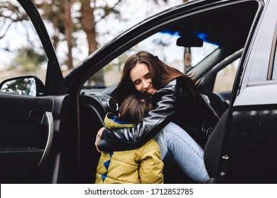 Happy Family Travel By Car In The Forest. Beautiful Woman With A Child Of 3 Years In The Car Are Going To Have A Trip. Spring Or Fall Vacation Concept. Mom Hugging Her Son.