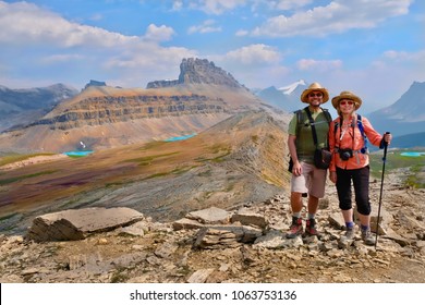 Happy family  travelling in Canadian Rockies. Active man and woman hikers  on trail. Dolomite Mountains in Banff National Park. Rocky Mountains.  Alberta. Canada. - Powered by Shutterstock