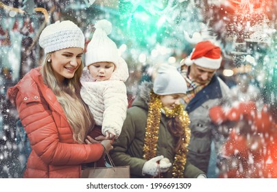 Happy Family With Two Beautiful Children Female Children Spending Time At Christmas Fair