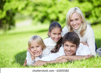 A Happy Family With Two Children Outdoors