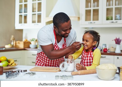 Happy Family Of Two Cooking Together At Home