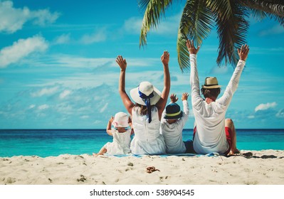 happy family with two kids hands up on the beach - Shutterstock ID 538904545