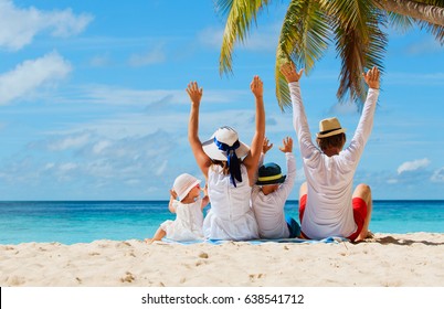 happy family with two kids hands up on beach - Shutterstock ID 638541712