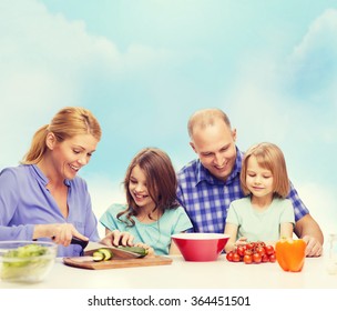 Happy Family With Two Kids Making Dinner At Home