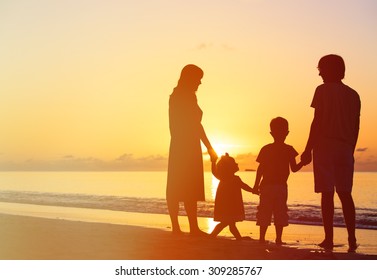 Happy Family With Two Kids On Sunset Tropical Beach