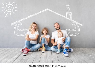 Happy family with two kids playing into new home. Father, mother and children having fun together. Moving house day and real estate concept