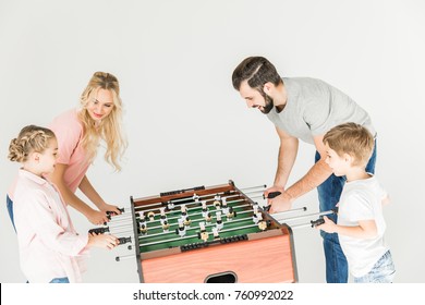 Happy Family With Two Kids Playing Table Football Together Isolated On White 