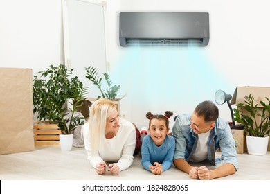 Happy Family Under Air Conditioning At Home