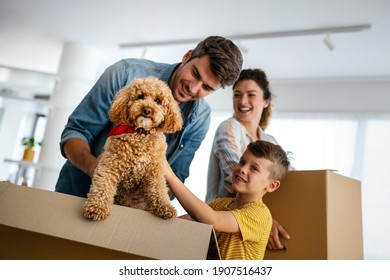 Happy Family Unpacking Boxes In New Home On Moving Day