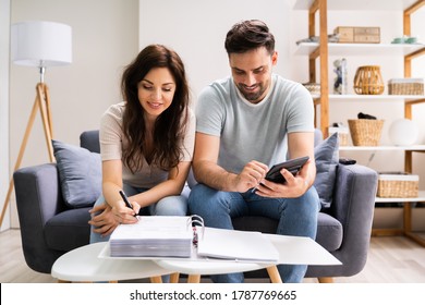 Happy Family Using Calculator For Tax And Budget