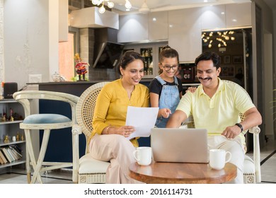 Happy Family Using Laptop Together At Living Room