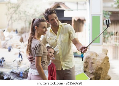 Happy Family Using A Selfie Stick At The Zoo