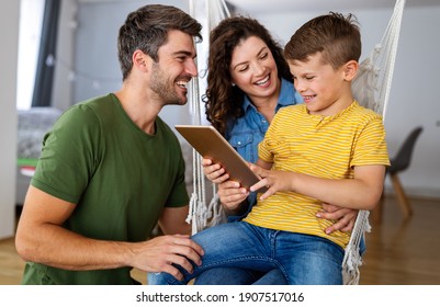 Happy Family Using Technology Devices Together At Home.