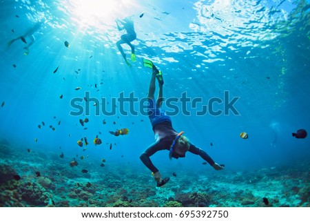 Happy family vacation. Man in snorkeling mask with camera dive underwater with tropical fishes in coral reef sea pool. Travel lifestyle, water sport outdoor adventure, swimming on summer beach holiday