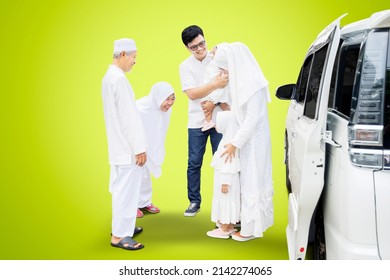 Happy Family Visiting Grandparents During Eid Mubarak While Standing Next To A Car In The Studio With Green Screen Background