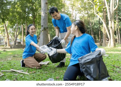 Happy Family Volunteering Together in a Park, Collecting Trash and Promoting Environmental Awareness and Community Service - Powered by Shutterstock