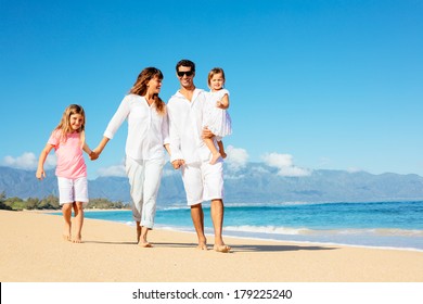 Happy Family Walking On The Beach