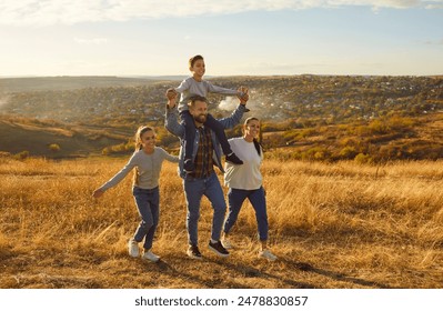 Happy family walking on golden field at sunset father mother son and daughter. Happy family serene ambiance deep connection admire tranquil beauty of expansive yellow meadow Happy family walking - Powered by Shutterstock