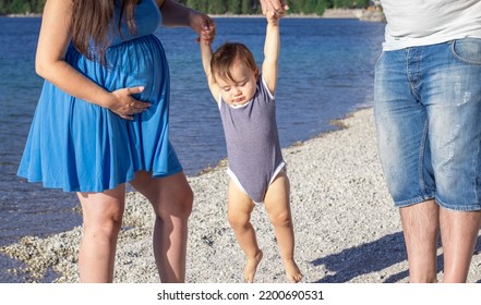 Happy Family Walking On Lakeside With Baby Boy Toddler Infant.pregnant Woman Expecting Second Baby.man Woman Hold Child From Hands Lift Up Let Him Down.mountains,family Time