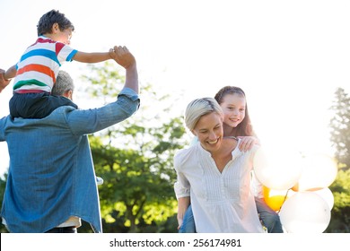 Happy Family Walking At The Park