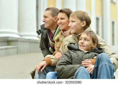 Happy Family Walking In The Park On Weekends