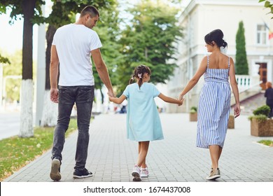 Happy Family Walking Together In The Street Of The City