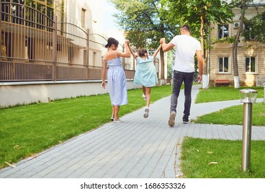 Happy Family Walking Together In The Street Of The City