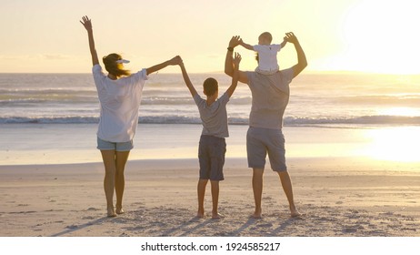 Happy family walks in the beach in the sun at sunset. Mom, dad and baby happy walk at sunset. Joint family walks healthy lifestyle. The concept of a happy family and family values.