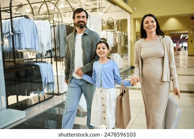 A happy family walks through a bustling shopping mall, joyfully holding shopping bags as they enjoy a weekend outing together. - Powered by Shutterstock