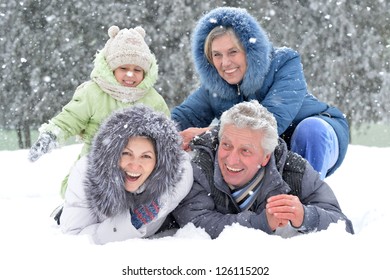 Happy Family In Warm Clothing In Winter Outdoors