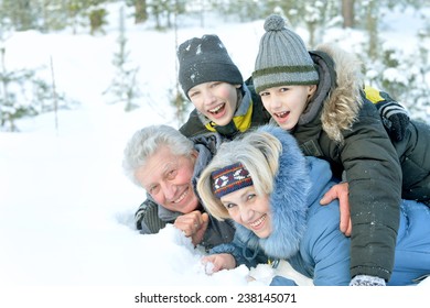 Happy family in warm clothing in winter outdoors