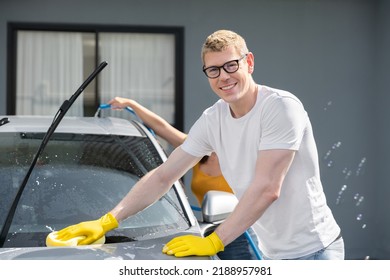 Happy Family Wash And Clean An Automative Car At Home Garage With Water Jet And Shampoo Wax  On Weekend