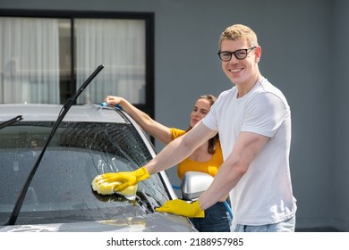 Happy Family Wash And Clean An Automative Car At Home Garage With Water Jet And Shampoo Wax  On Weekend