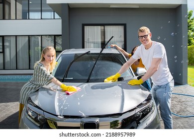 Happy Family Wash And Clean An Automative Car At Home Garage With Water Jet And Shampoo Wax  On Weekend