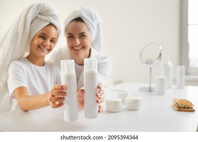 Happy Family Washing Hair In Morning. Smiling Beautiful Mom And Kid In Bathroom Towels Show Clean Mockup Plastic Shampoo Bottles. Dermatology Products In Children And Adults' Haircare Routine Concept